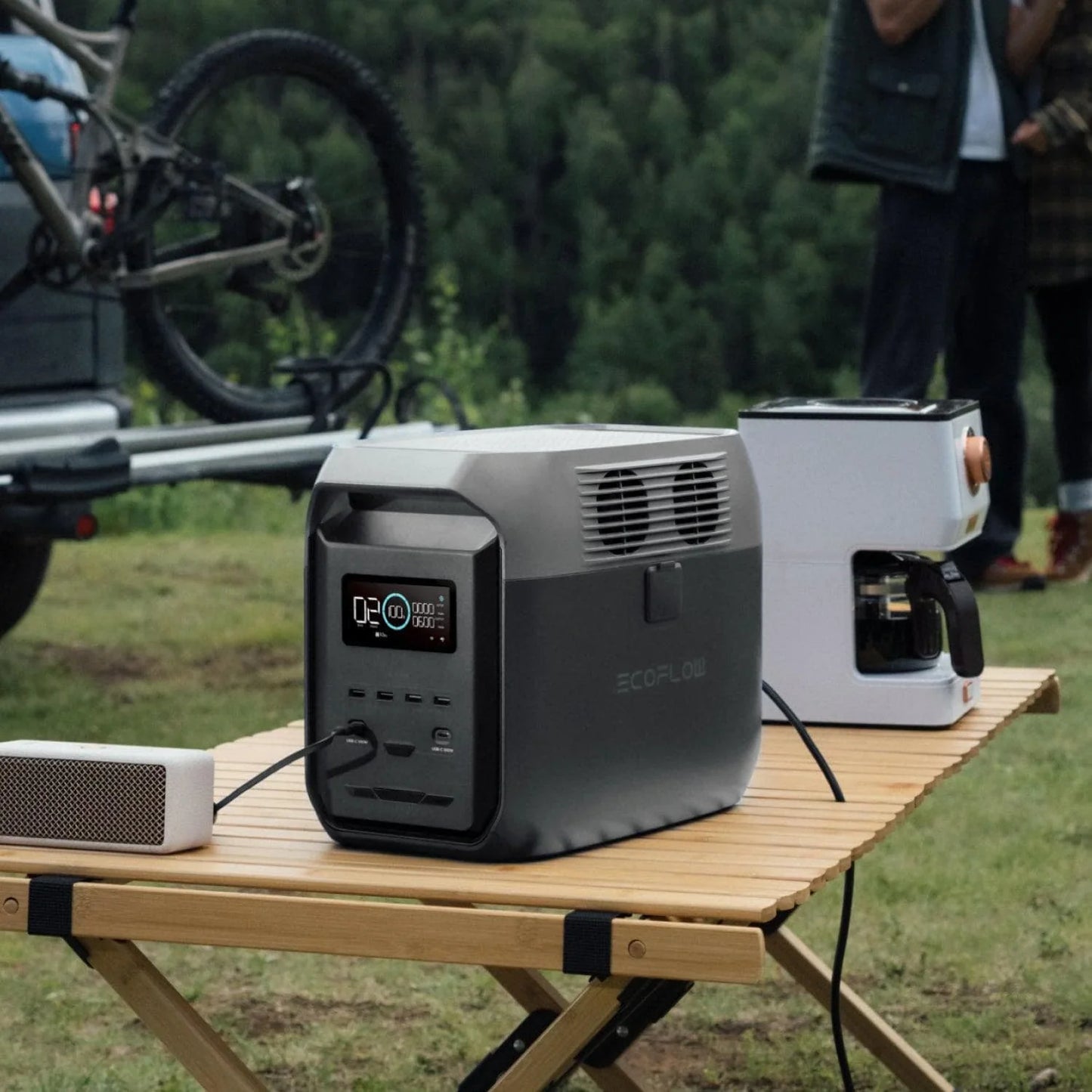 EcoFlow Delta 3 1500 Portable Power Station powering a coffee maker and speaker outdoors near a camper van