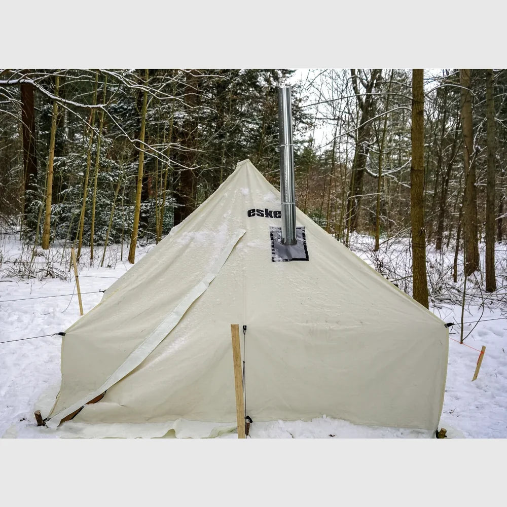 Esker Classic 10x10 winter tent pitched in a snowy forest