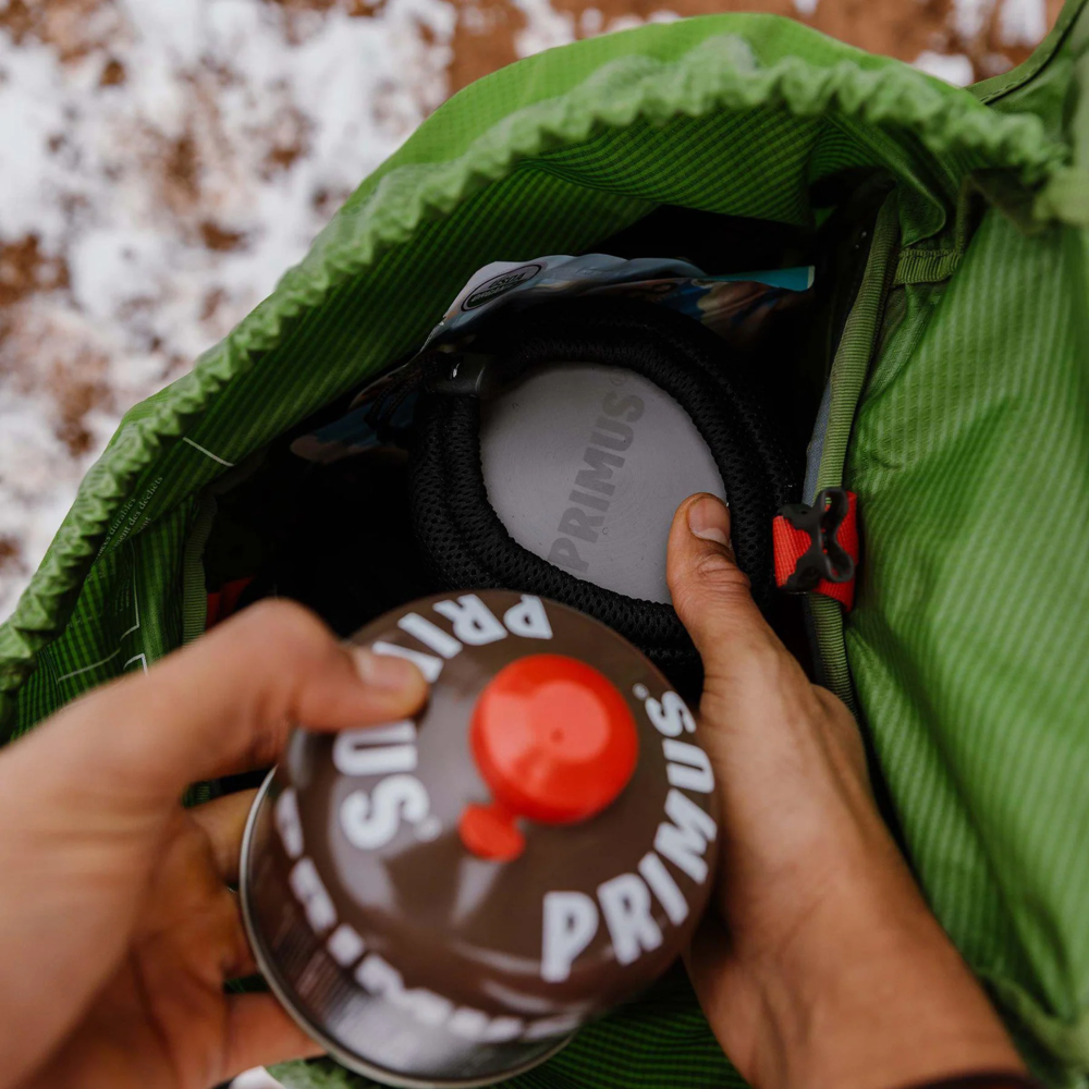 Primus backpacking gas canister stored inside hiking backpack