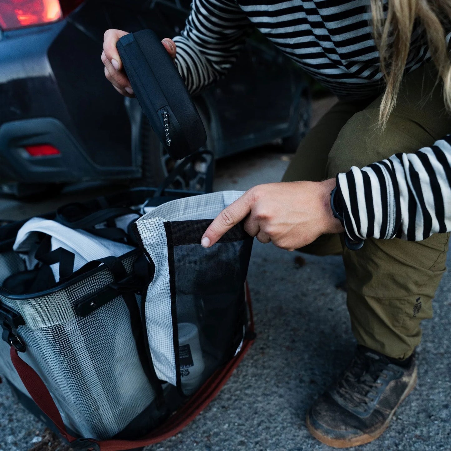 Rux 2L Packing Pocket Mesh in use outdoors organizing gear in vehicle storage