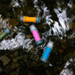 Platypus quickdraw filters floating in shallow stream water showing multiple colour options.