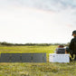 EcoFlow 60W solar panel charging a portable power station in a field
