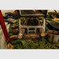 Esker Baffin wood stove set up with stovepipe and stacked firewood for winter hot tent camping