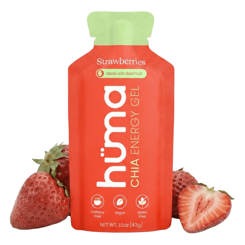 Huma Chia Energy Gel Strawberry flavor 1.5oz packet front hero on white background showing red packet with green cap, Strawberries flavor name, Made with Real Fruit badge, h√ºma Chia Energy Gel branding, and Caffeine Free Vegan and Gluten Free icons, flanked by fresh strawberries