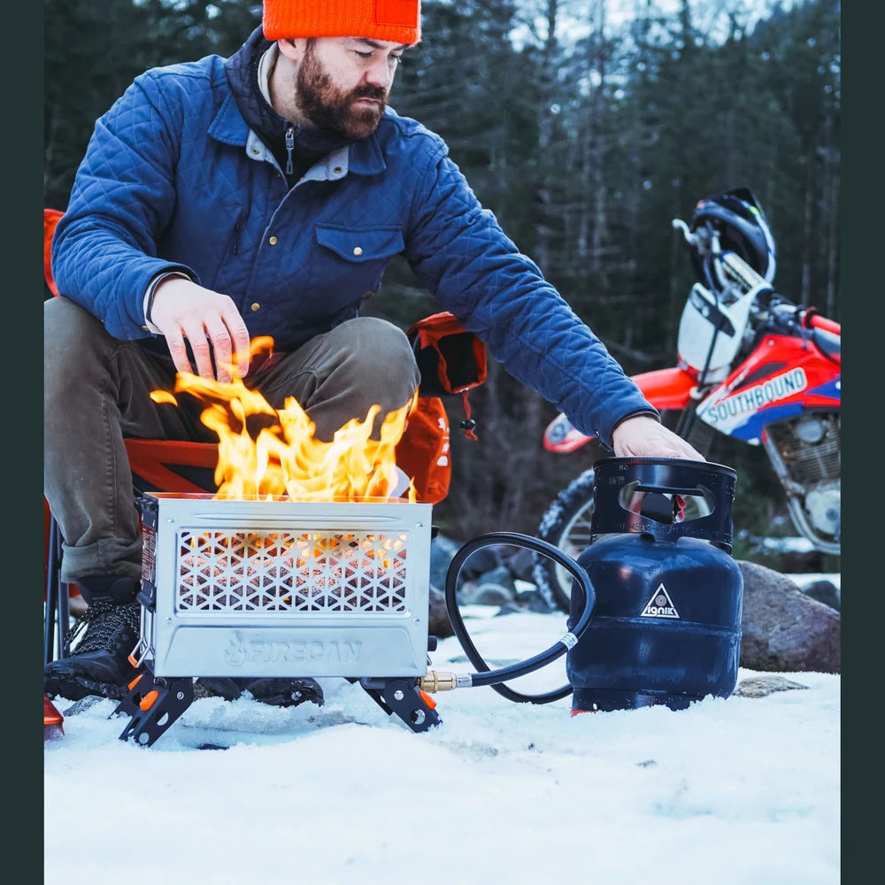 Ignik Propane Growler Tank powering a FireCan propane fire pit while winter camping in the snow