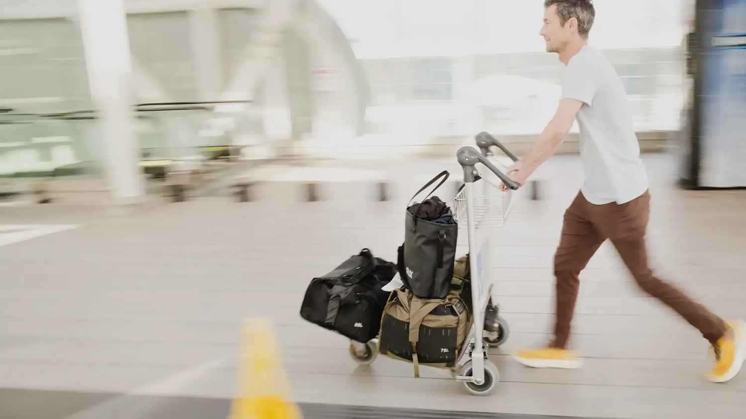 Rux 55L Duffel shown on airport cart