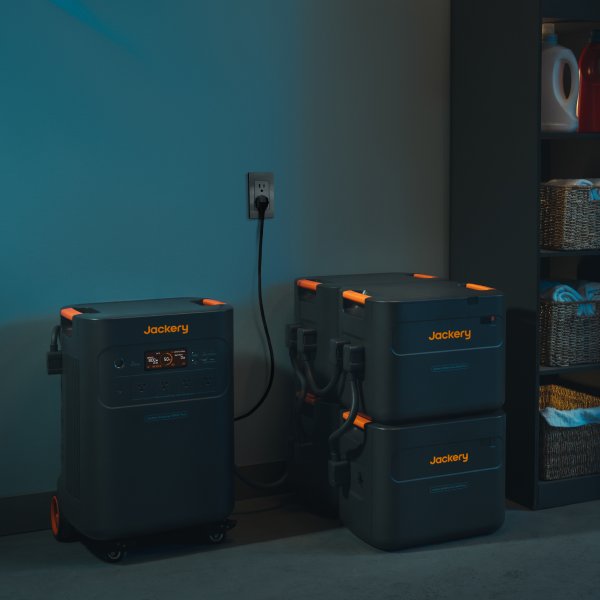 Jackery Explorer 5000 Plus charging indoors from an AC wall outlet.