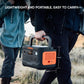 Person carrying Jackery Explorer 600 Plus portable power station with visible size dimensions.