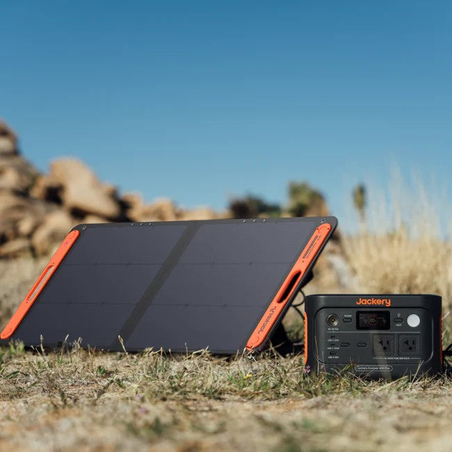 Jackery Explorer 600 Plus connected to SolarSaga panel charging outdoors in sunlight.