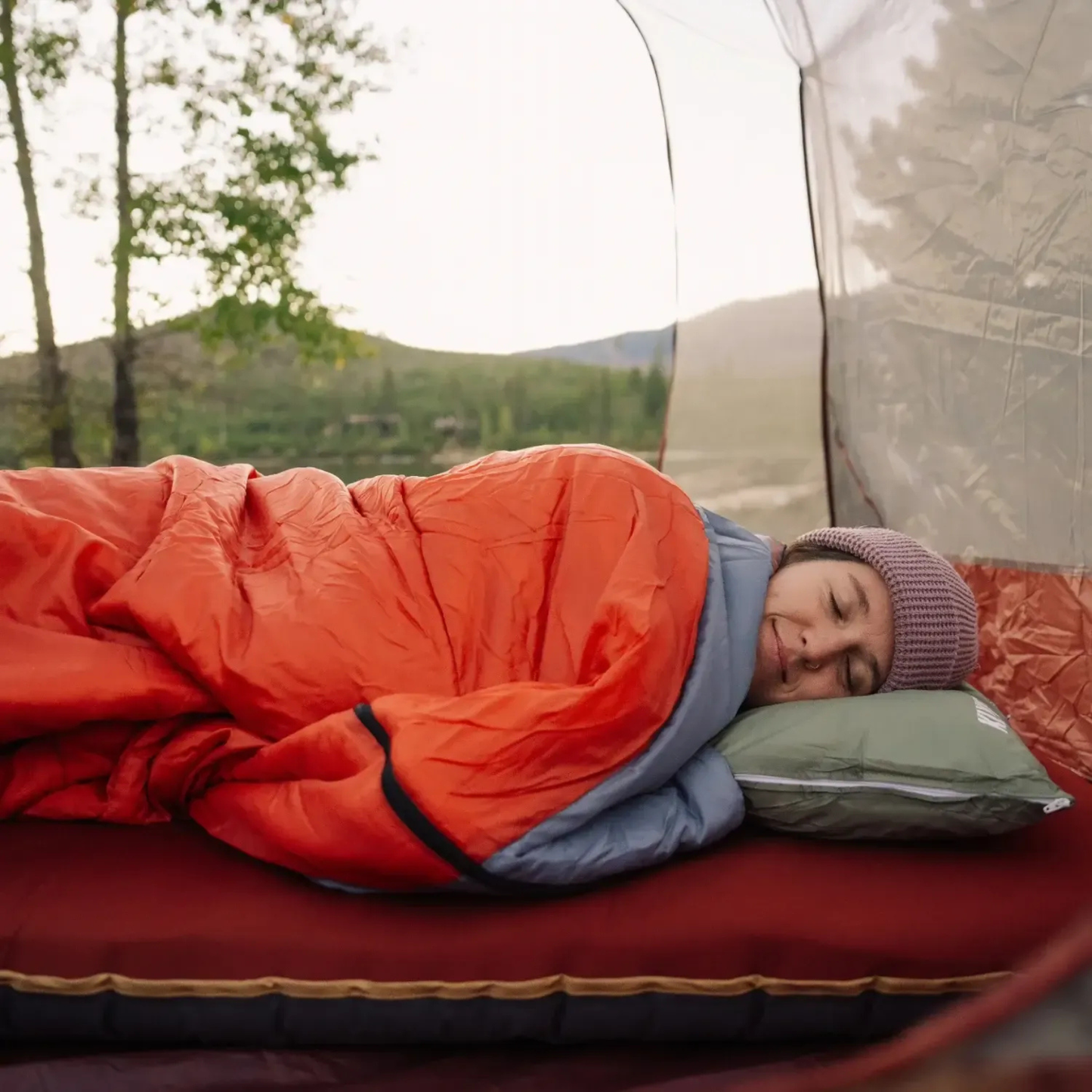 person sleeping comfortably in Klymit Bozeman 35 Large sleeping bag inside tent