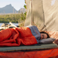 person sleeping outdoors in Klymit Bozeman 35 Large sleeping bag on sleeping pad in tent