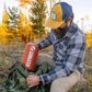 Man packing Klymit sleeping pad into backpack for hiking and backcountry camping