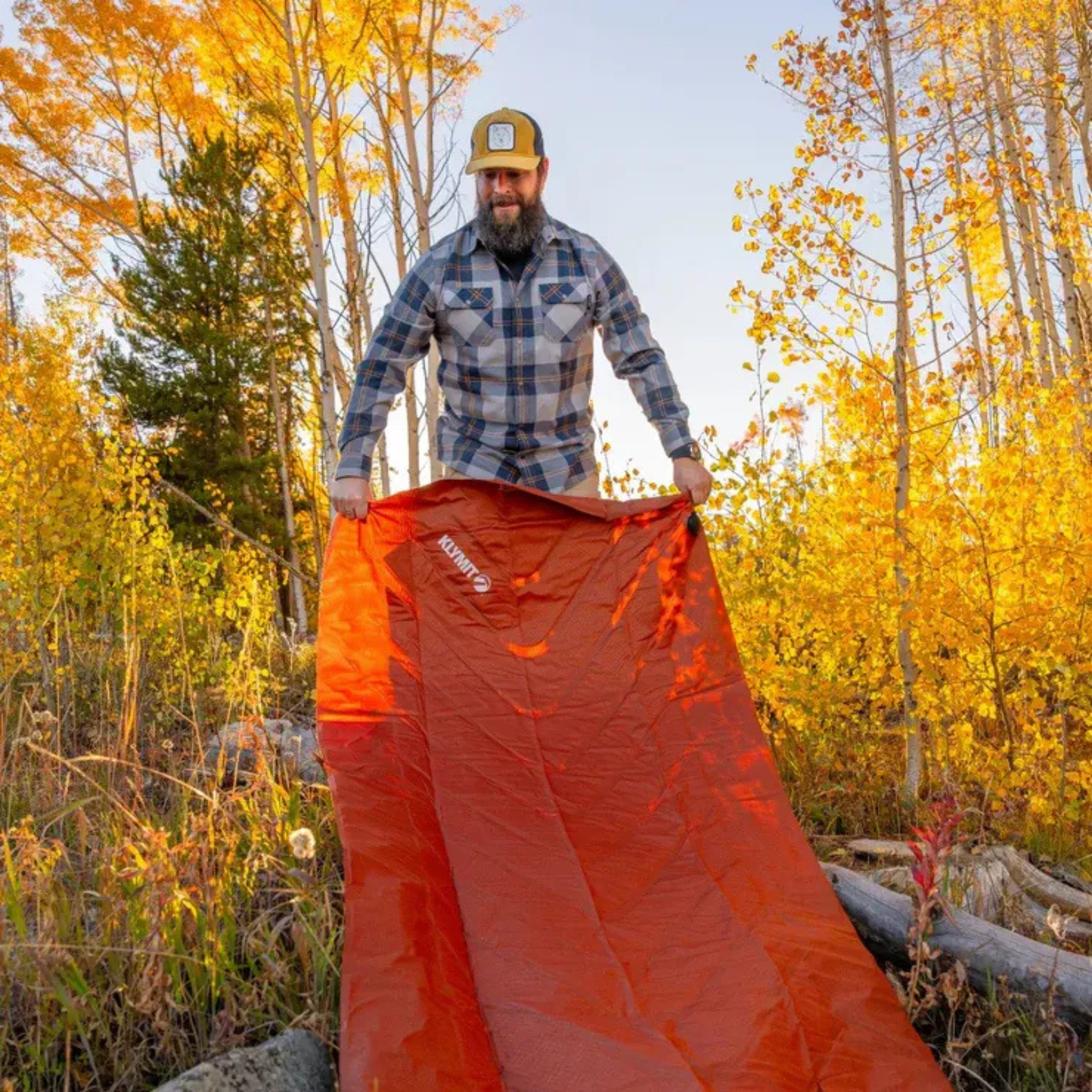 Klymit Static V Peak XL sleeping pad being set up outdoors for camping in autumn forest