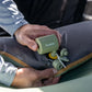 Klymit Tempest USB Pump attached to camping sleeping pad for fast cordless inflation outdoors.
