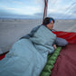 person resting inside tent using Klymit Wild Aspen 20 sleeping bag on sleeping pad