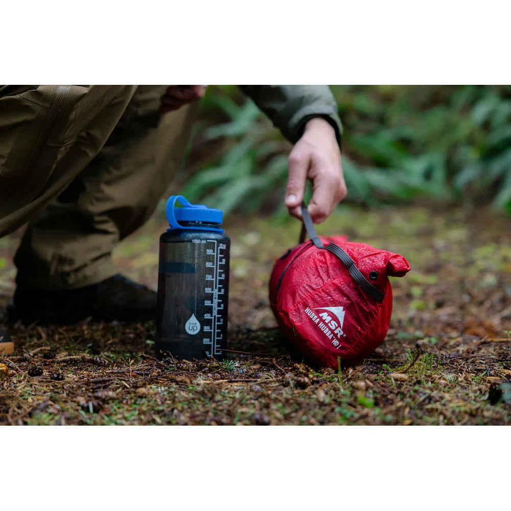 MSR Hubba Hubba HD 1 tent stuffsack next to 1L water bottle on forest floor showing ultra-compact packed size for solo backpacking on Vancouver Island