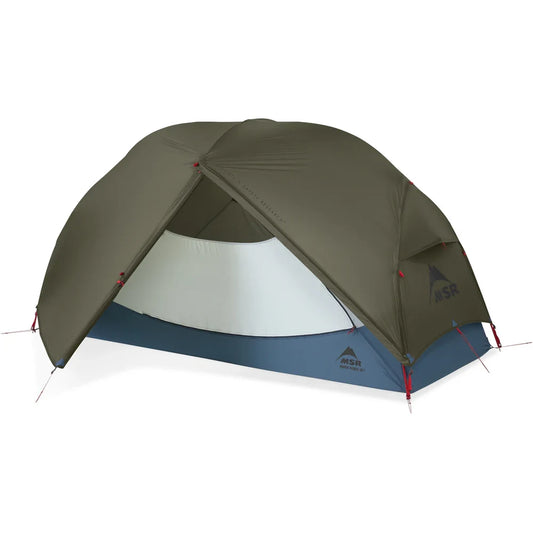 MSR Hubba Hubba HD 1-Person Tent fully pitched with olive green rainfly and front vestibule door open revealing compact interior and blue waterproof floor
