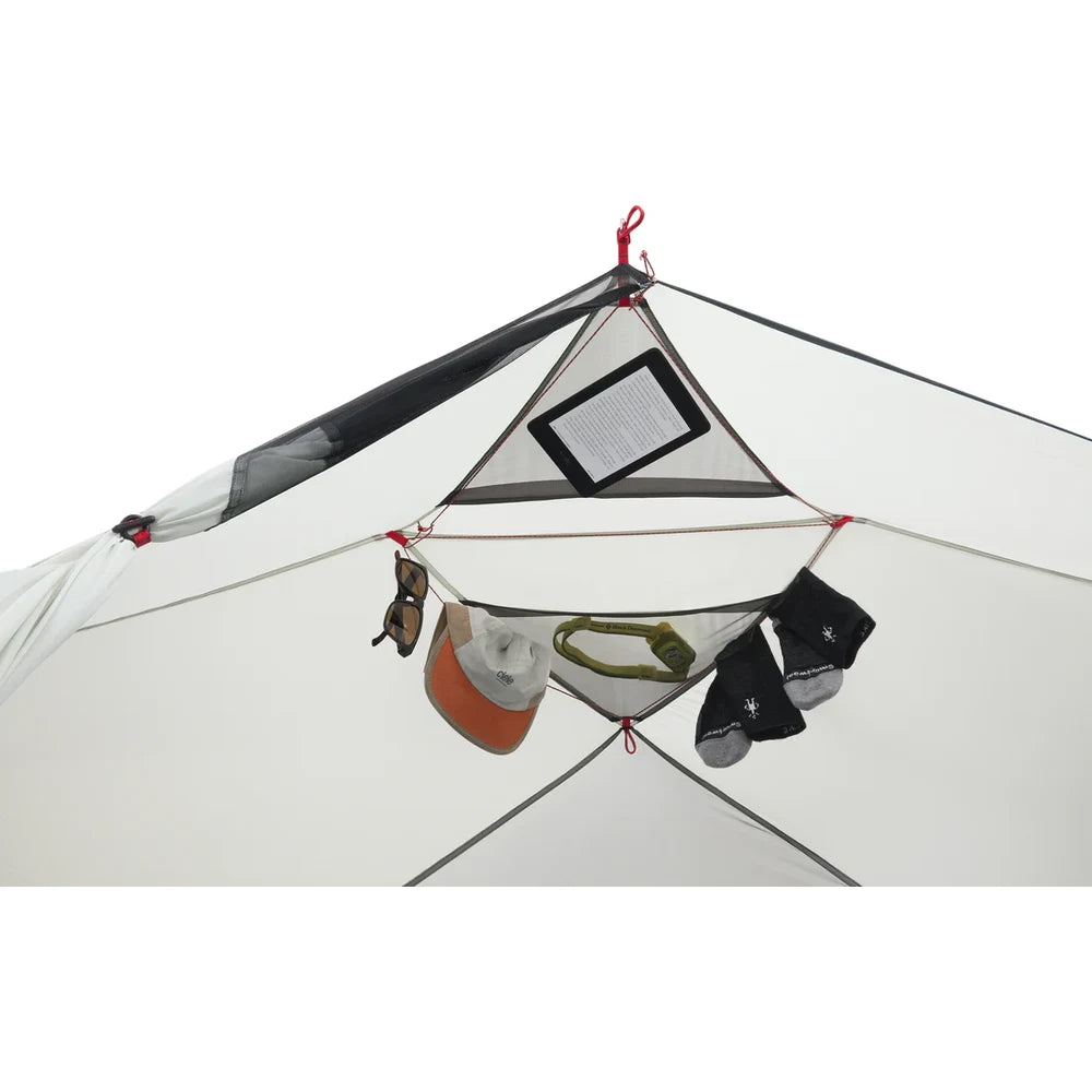 Overhead triangular gear loft and clothesline of MSR Hubba Hubba HD 1 tent with hat, sunglasses, socks, headlamp and e-reader stored and hanging to dry