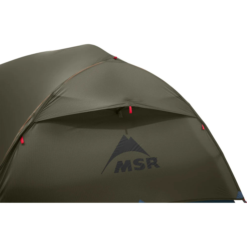 Detail of MSR Hubba Hubba HD 2 tent rainfly kickstand vent and MSR logo on olive green 20D ripstop nylon fly with guy line attachment point