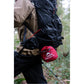 Backpacker hiking rainy Vancouver Island trail with MSR Hubba Hubba HD 2-Person Tent stuffsack attached to pack exterior, showing ultralight compact packed size
