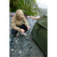Backpacker staking out MSR Hubba Hubba HD 2-Person Tent on rocky Vancouver Island beach in rainy weather, showing easy pitching and weatherproof olive rainfly