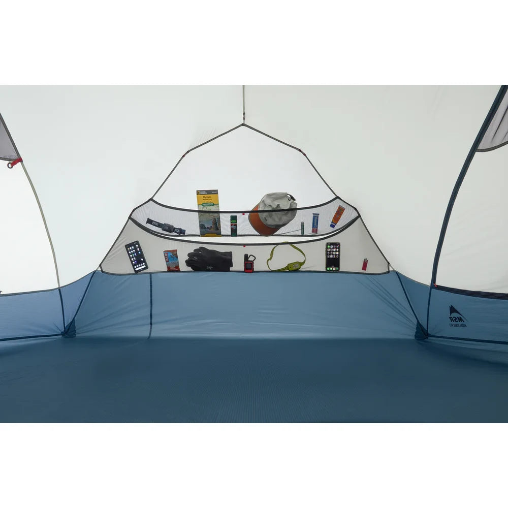 Interior end pocket of MSR Hubba Hubba HD 3 tent with cable port for charging devices, perfect for headlamp and phone storage while backpacking
