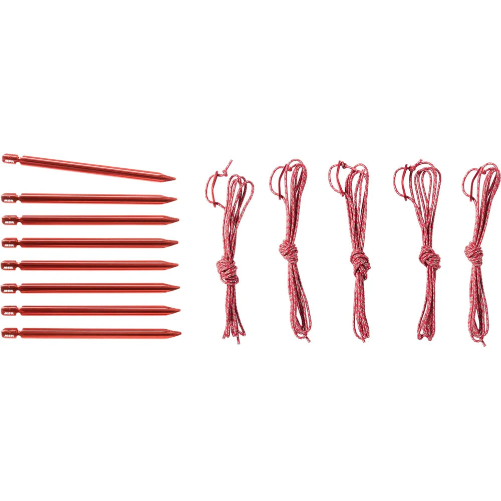 Included accessories for MSR Hubba Hubba HD tent: 8 Mini-Groundhog red aluminum tent stakes and 4 reflective guy lines on white background