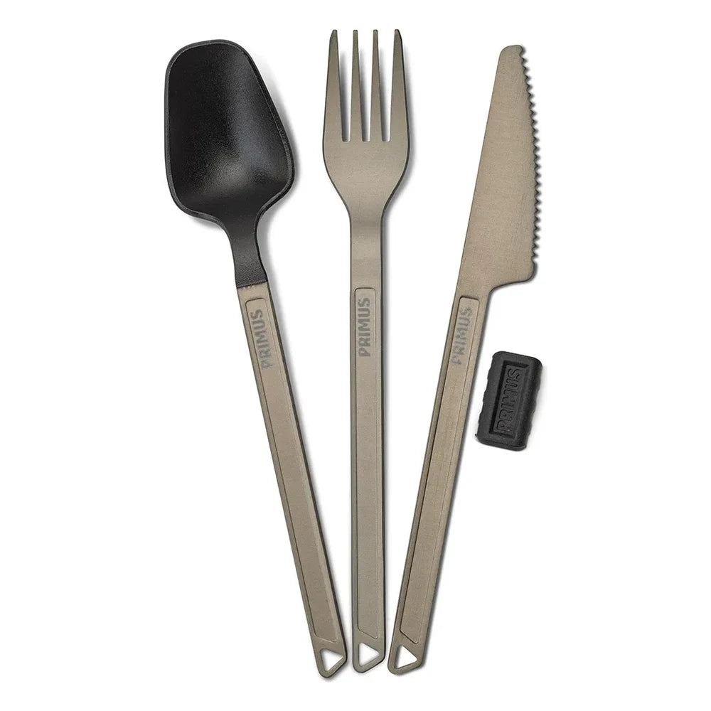 Complete Primus Trek Cutlery Set on white background showing anodized aluminum handled spoon with black nylon head, fork, serrated knife, and Primus knife guard for backpacking and camping