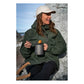 Person eating from Primus Trek Pot UL with Primus Trekking Spork at coastal hiking campsite with rocky shoreline and ocean in background