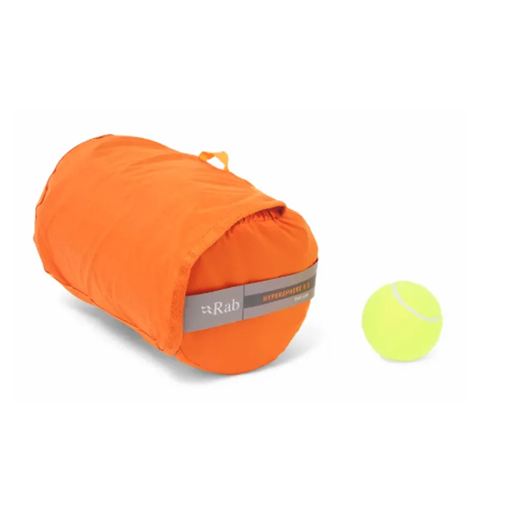 Rab Hypersphere 9.5 down sleeping mat packed in its orange stuff sack beside a tennis ball for size comparison