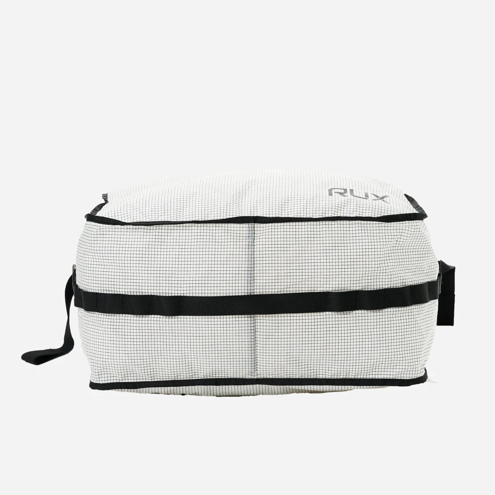 Rux 20L packing bag bottom view showing reinforced base and compression strap system