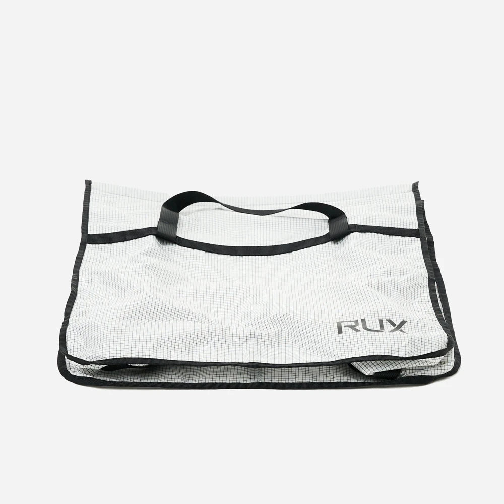 Rux 20L packing bag folded flat demonstrating packability and space saving storage