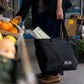 RUX 30L Waterproof Tote lifestyle image featuring black waterproof tote grocery shopping lifestyle