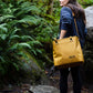 RUX 30L Waterproof Tote lifestyle image featuring bronze waterproof tote hiking trail outdoor lifestyle