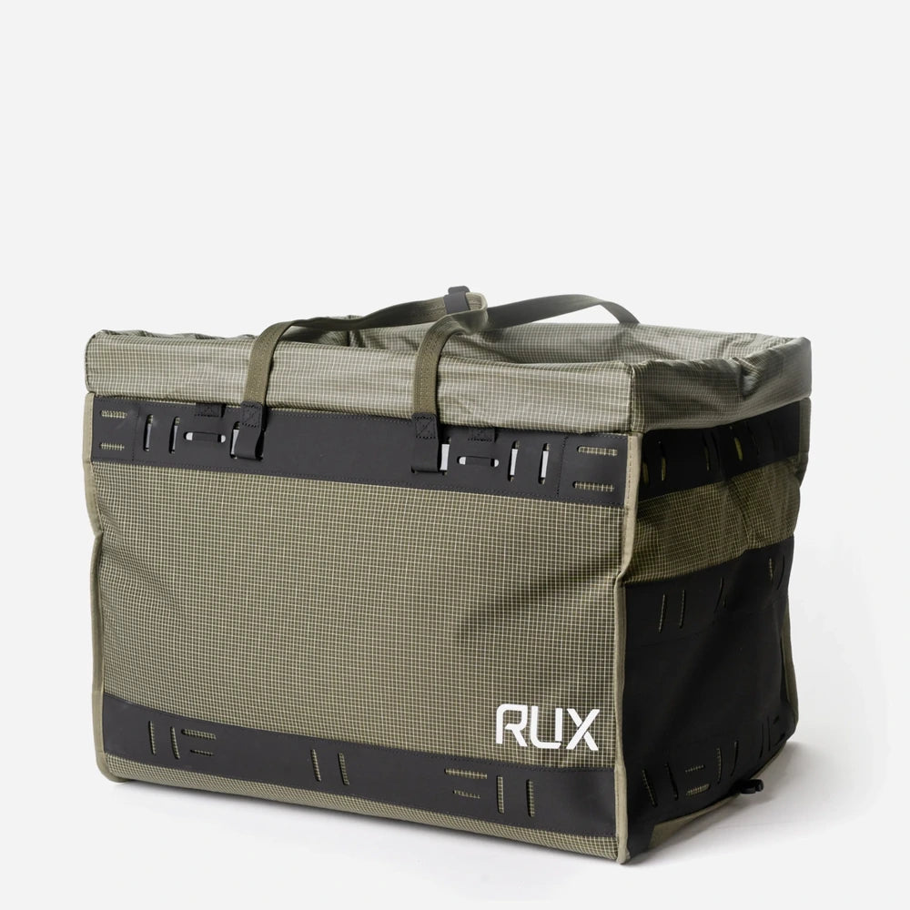 RUX 55L Duffle Box side profile showing carry straps and logo. 