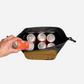 RUX 5L Cooler in bronze shown open with multiple beverage cans inside the insulated compartment.