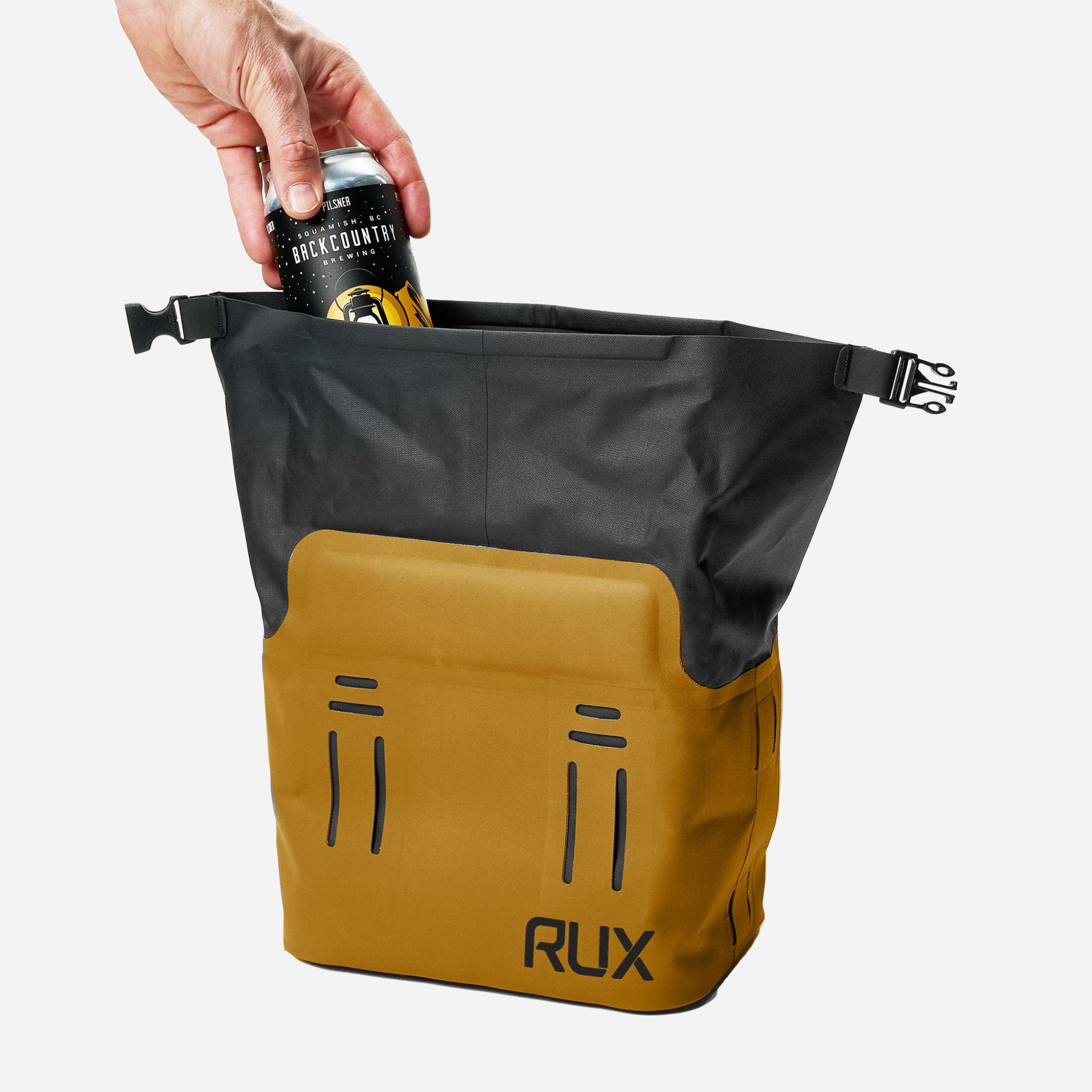 RUX 5L Cooler in bronze with a hand placing a beverage can into the open cooler.