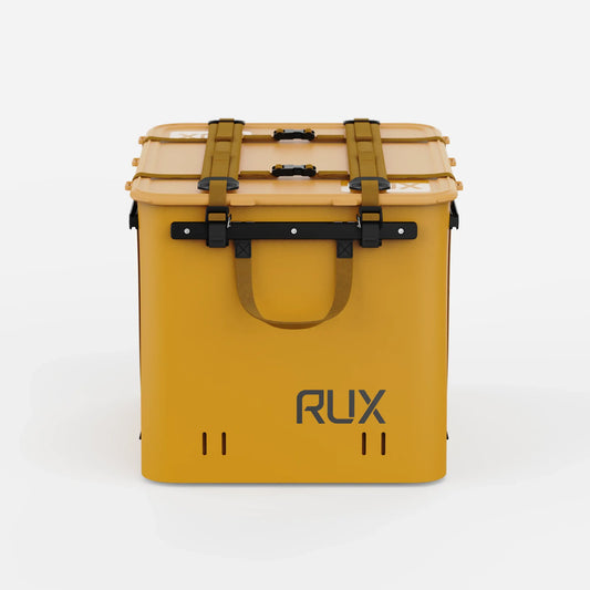 Rux 70L Press-Seal bronze container front view with dual lid straps, buckle closures, carry handle, and Rux logo.