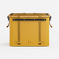 Rux 70L Press-Seal bronze container rear view showing vertical straps, black rail hardware, and reinforced storage design.