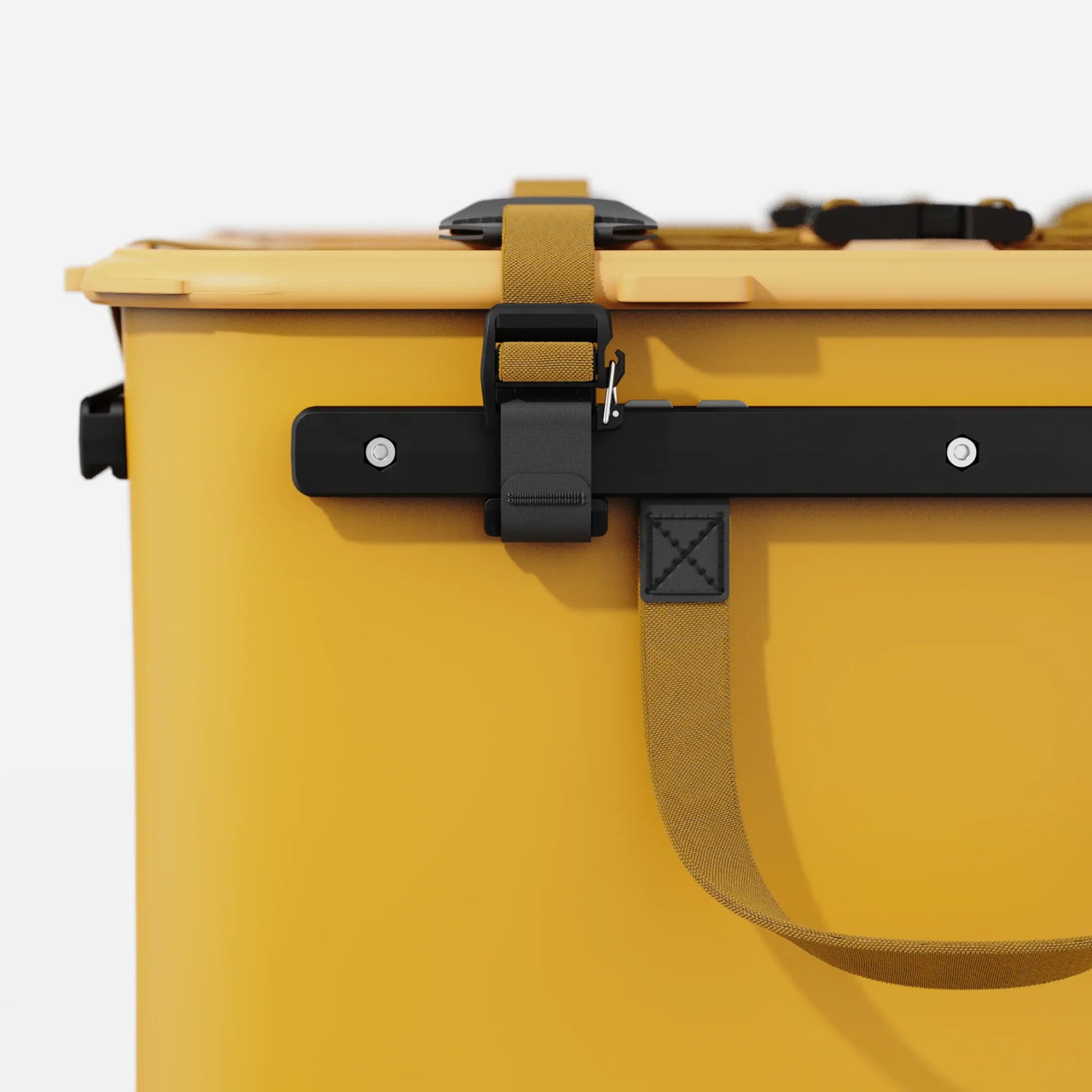 Rux 70L Press-Seal bronze  container side close-up showing buckle, black rail, strap hardware, and stitched handle attachment.