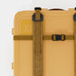 Rux 70L Press-Seal bronze container top detail showing lid strap, buckle, reinforced rail, and compression closure system.