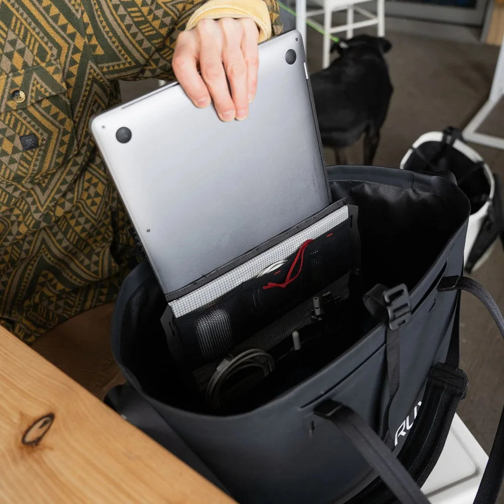 Laptop being stored inside RUX waterproof tote bag with organizational