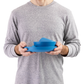 Person holding Sea to Summit camp dinnerware set in blue showing compact stacked design