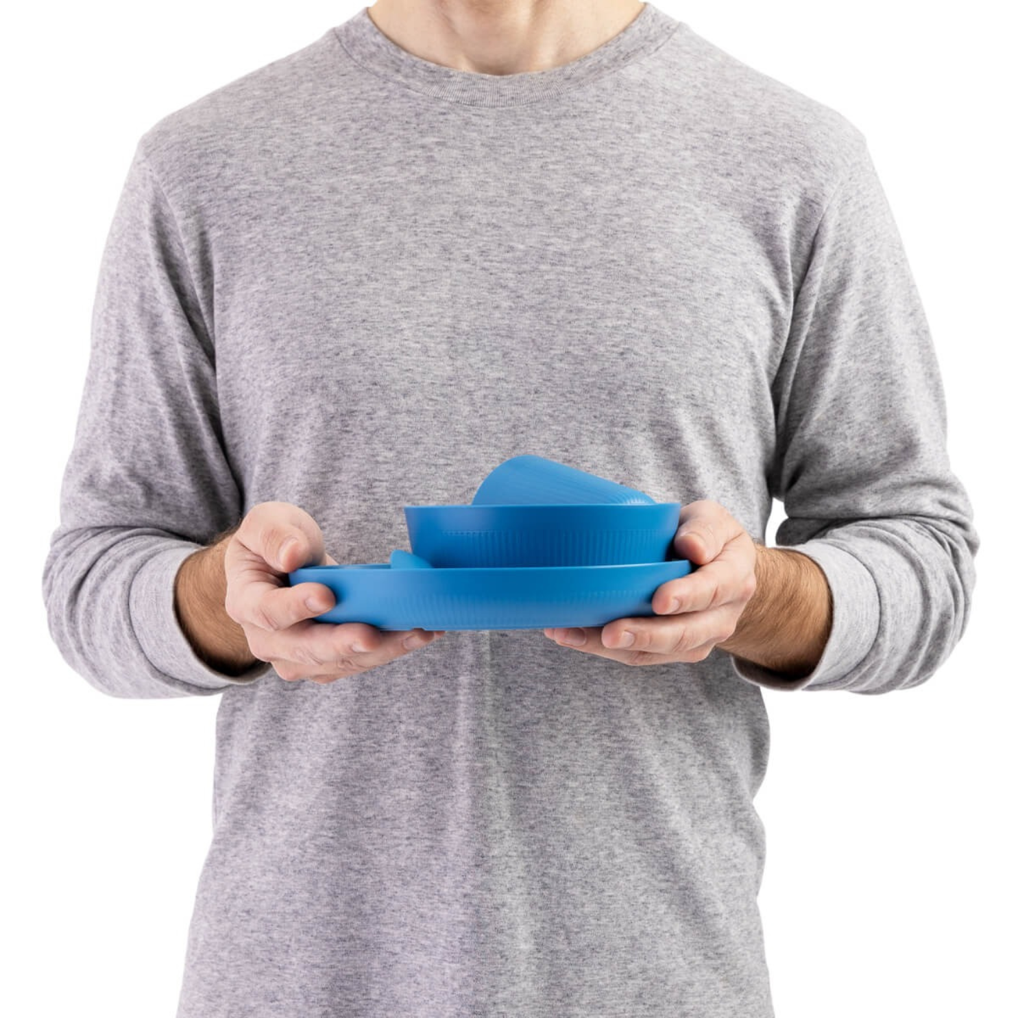 Person holding Sea to Summit camp dinnerware set in blue showing compact stacked design