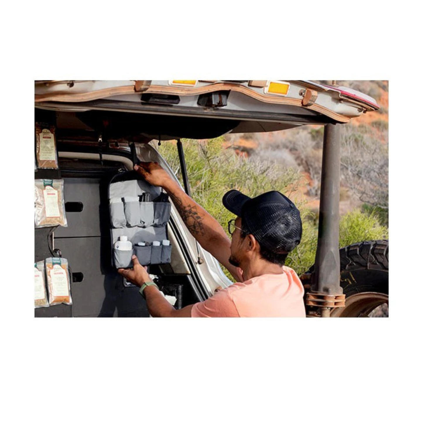 Sea to Summit Camp Kitchen Tool Kit hanging in overland vehicle setup with bottles and cooking essentials organized