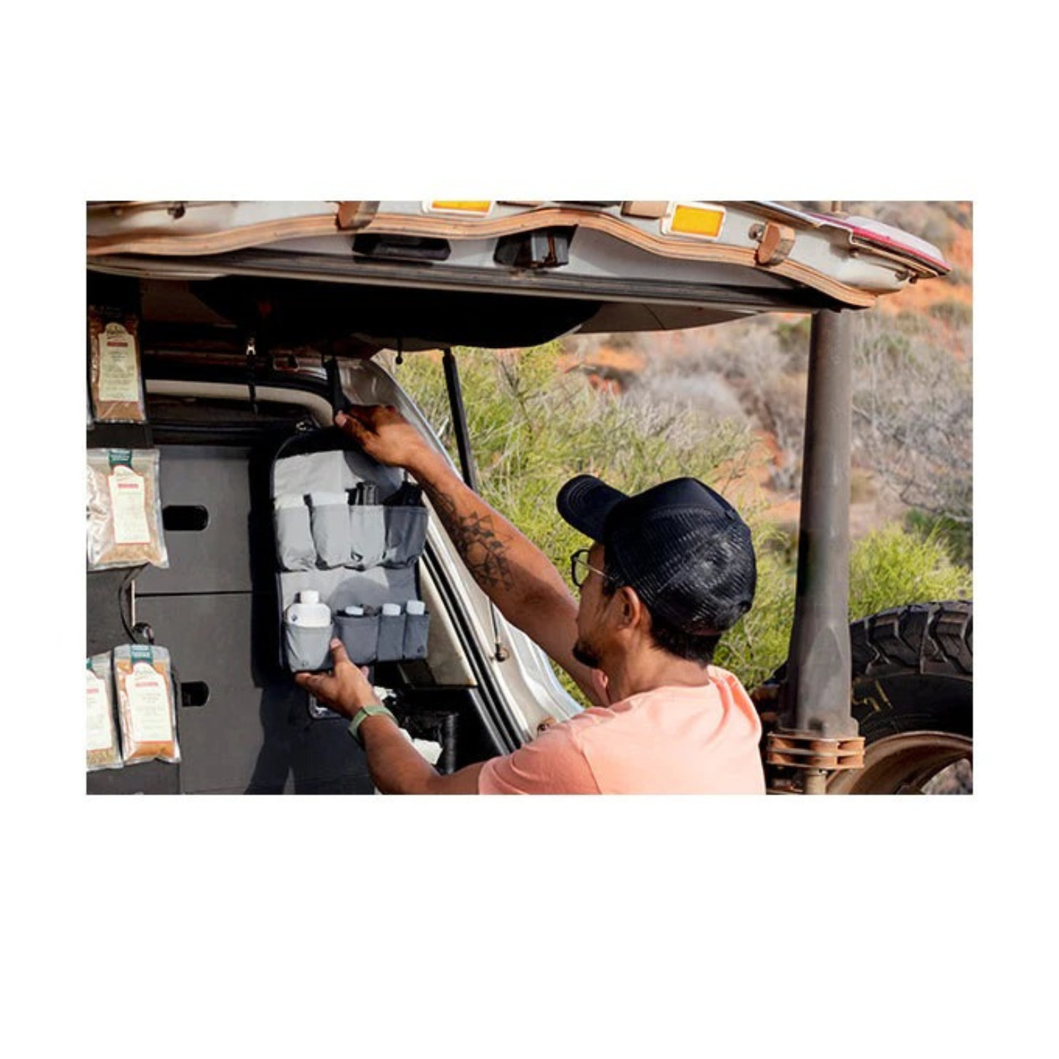 Sea to Summit Camp Kitchen Tool Kit hanging in overland vehicle setup with bottles and cooking essentials organized