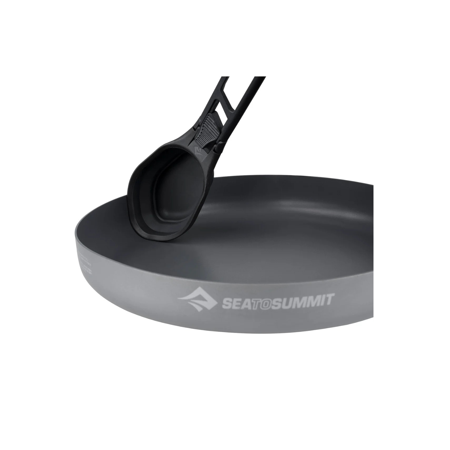 Sea to Summit folding spoon resting in non stick camping pan showing full size spoon bowl