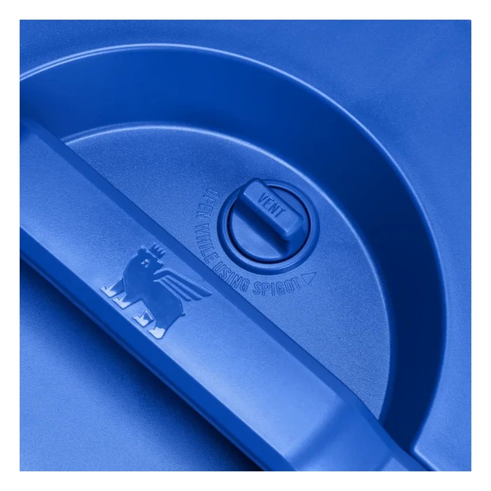 Stanley Adventure Fast Flow Water Jug 2 Gallon in Cobalt Chartreuse lid detail close-up on white background showing the vent dial on the cobalt blue lid with Open While Using Spigot instruction text, and the Stanley winged bear icon embossed on the carry handle bridge