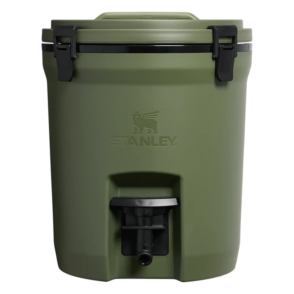 Stanley Adventure Fast Flow Water Jug 2 Gallon in Dried Pine front hero on white background showing olive green cylindrical body with Stanley winged bear embossed logo, black fast-flow spigot with lever handle at the front base, and black latch hardware securing the lid