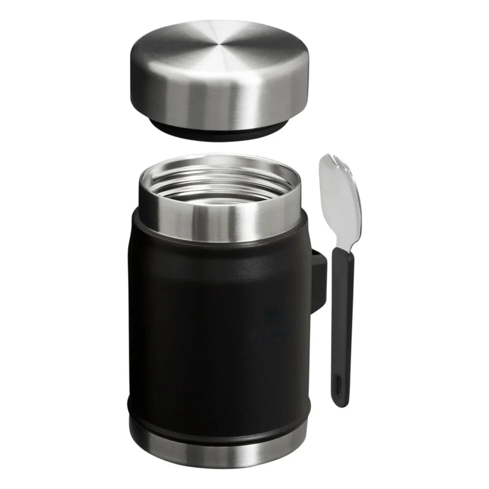 Stanley Adventure To-Go Food Jar and Spork 24oz in Matte Black exploded view on white background showing all components separated: polished stainless steel lid floating above, open matte black jar body with stainless steel rim and threads visible, and black folding spork placed to the side